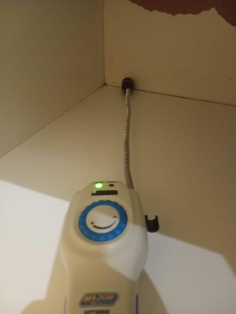 Acoustic leak detection probe tracing a pipe run inside a wall