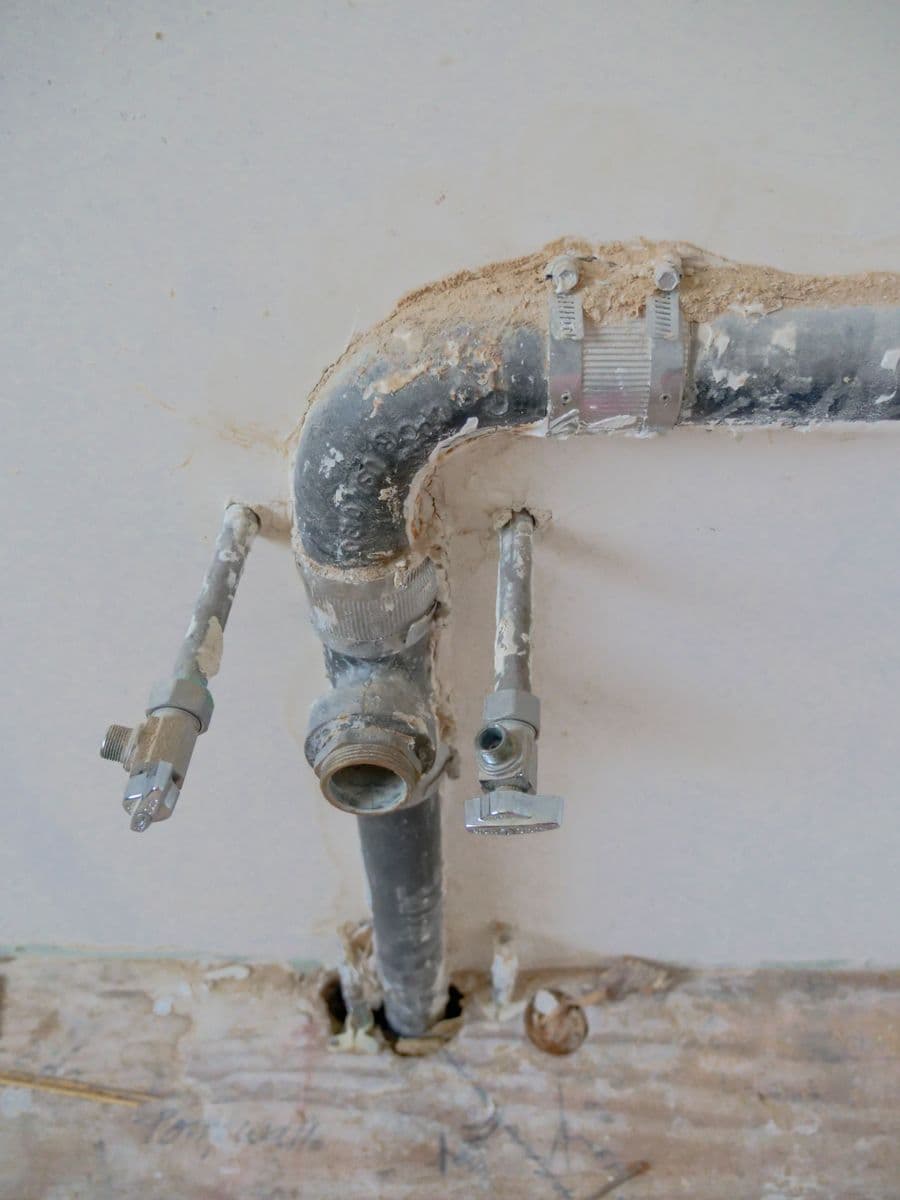 Exposed plumbing pipes being repaired